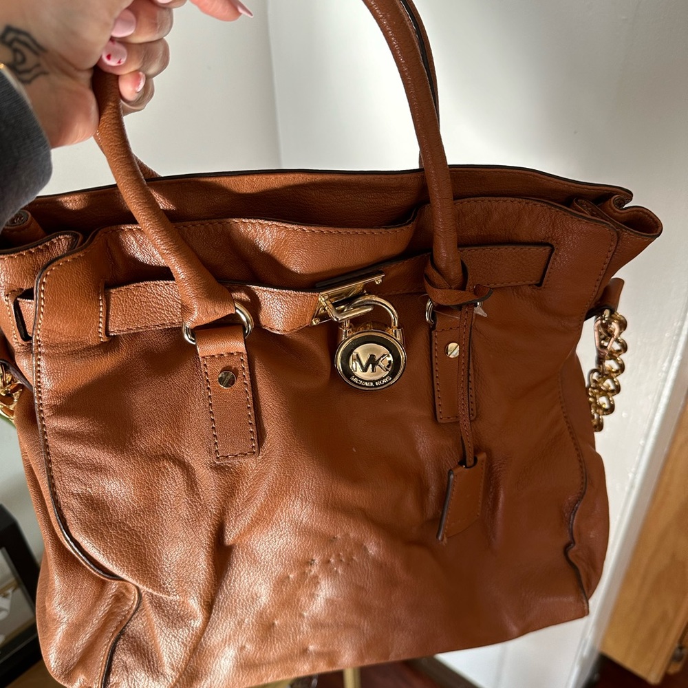 Brown leather, Michael Kors bag. Does have a lot of wear and tear.